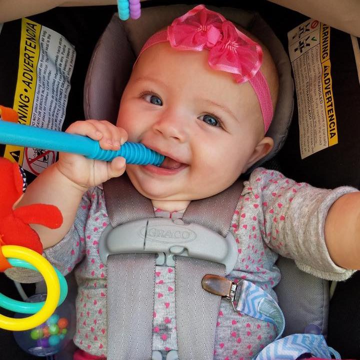 Happy baby using a teething tube