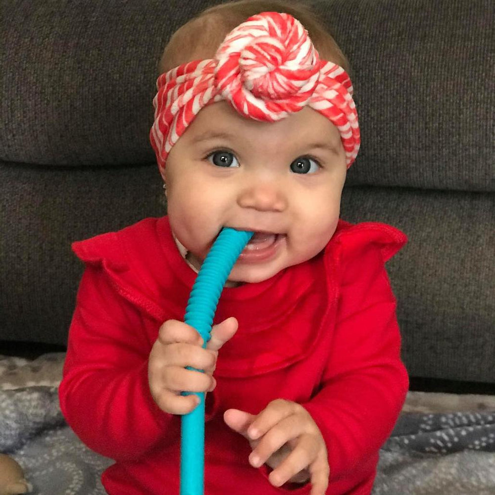 Happy baby using a teething tube