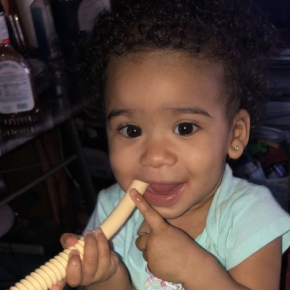 Happy baby using a teething tube
