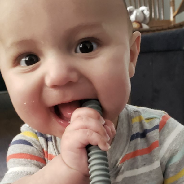 Happy baby using a teething tube