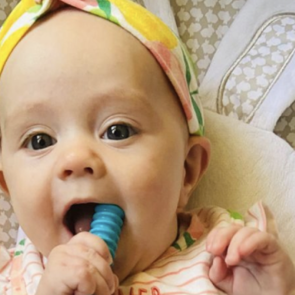 Happy baby using a teething tube